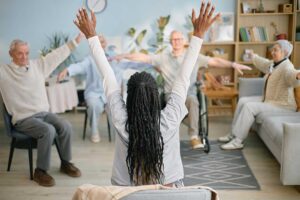 Elderly adults participating in a group activity, smiling and engaging with each other in a bright common area.